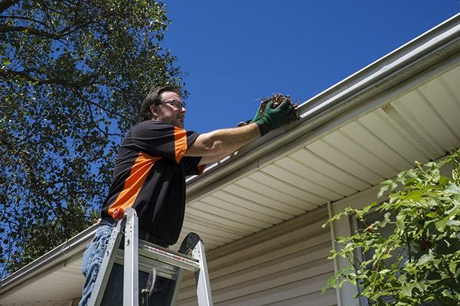 roofer fixing a sagging gutter on a building in Bent Mountain VA